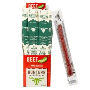 Jalapeño Grass Fed Beef Meat Sticks 24 Pack | Marvelli Artisan Breads Rows of green and white hunters reserve meat stick boxes labeled jalapeño flavor with a single wrapped meat snack to the right